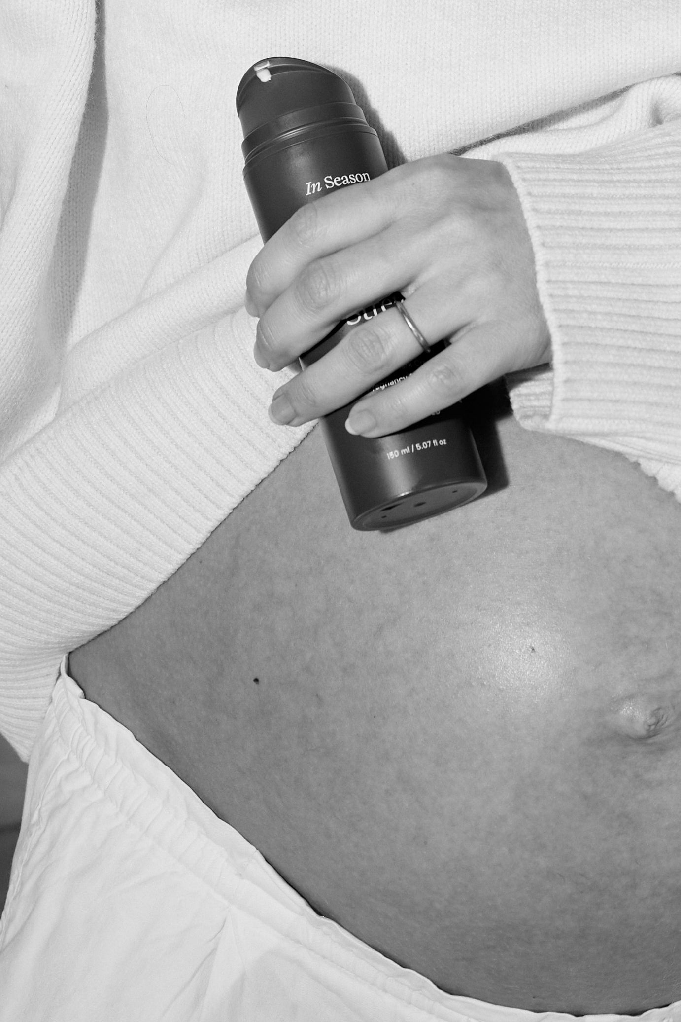 Pregnant women holding In Season Stretch Shield on belly